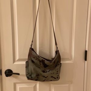 Italian leather shoulder bag with cowhide front and side panels.